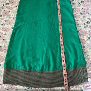 Hurley green dress with criss cross back and mesh-like hem.